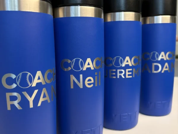 Coach tumbler engraving on blue YETI drinkware with personalized baseball names in Ottawa